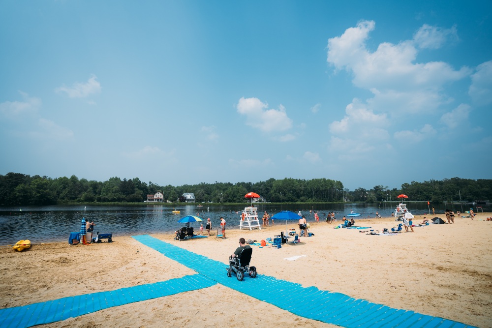 person testing electric chair and beach mats
