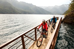 People riding bikes on a pedestrian bridge