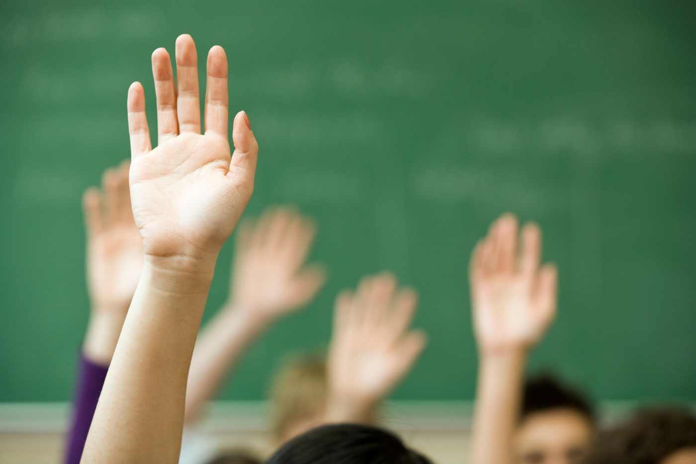 Hands raised in a classroom